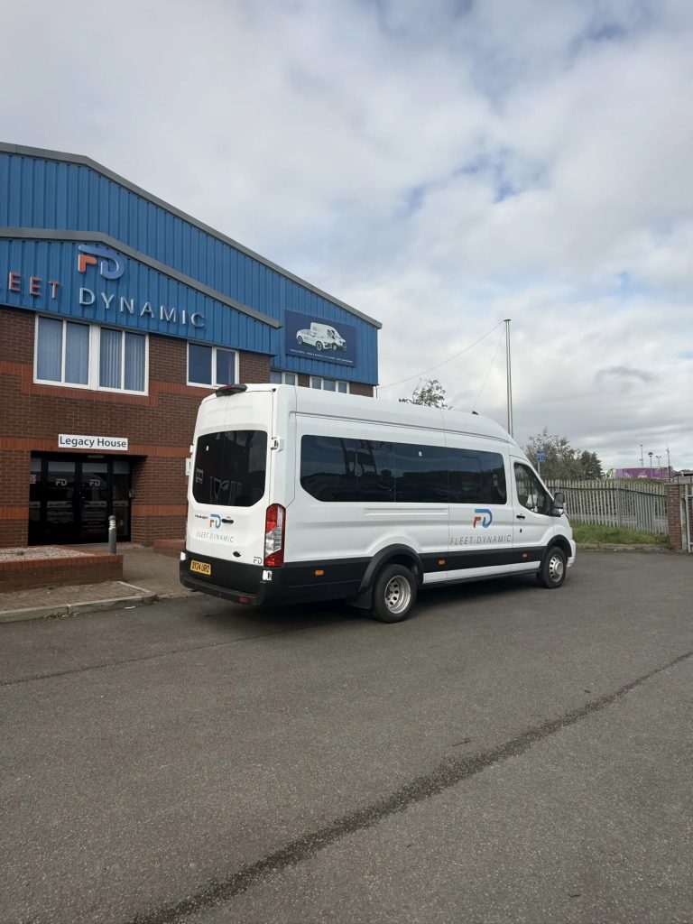 Fleet Dynamic 17-seater minibus outside the Wigan depot